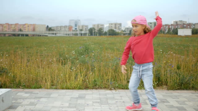Little-kid-dancing-and-rejoices-outdoors-on-the-outskirts-of-New-York-City.-Funny-Girl-Dancing.--4K-UHD.