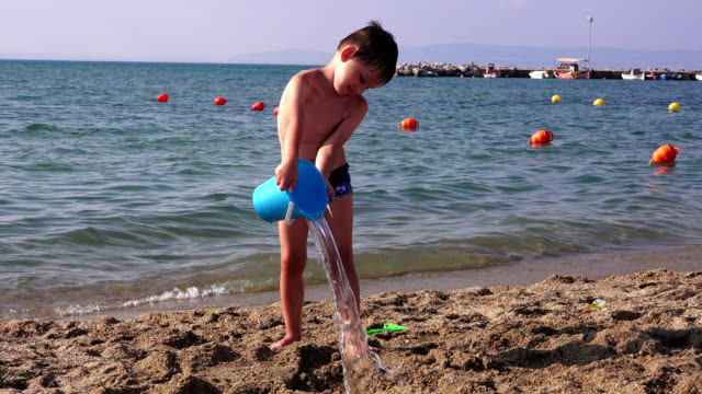 Little-boy-on-a-sea-beach,-Greece