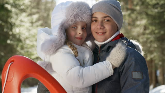 Portrait-of-Adorable-Siblings-in-Winter-Woods