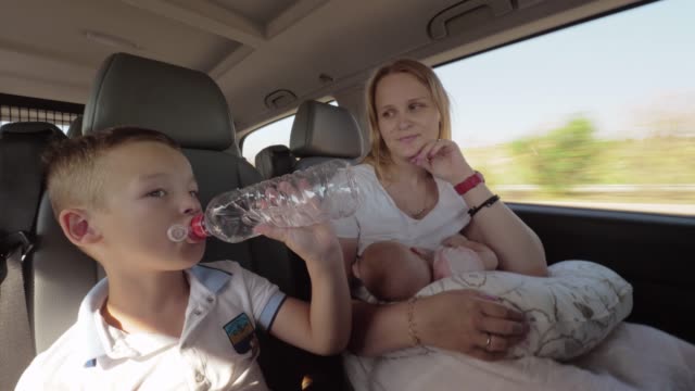 Mum-with-two-children-having-car-journey