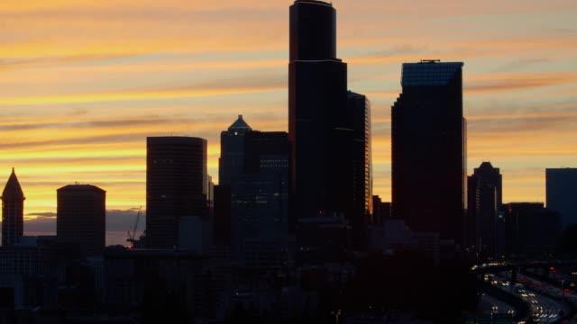 Golden-Orange-Clouds-Time-Lapse-with-Freeway-and-Skyline-Silhouette