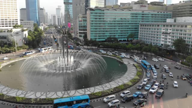 Aerial-view-clip-of-Selamat-Datang-monument-statue-or-Welcome-monument-of-Jakarta-with-road-traffic