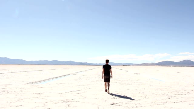 Man-Walking-Away-Across-Salt-Flats