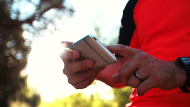 Mountain-biker-holding-a-smart-phone-with-tracking-app