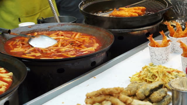 Seoul,-Korea-variety-of-Korean-street-food-stall,-tteokbokki,-fish-hotdog,-sausage-and-other-fried-food-on-stick