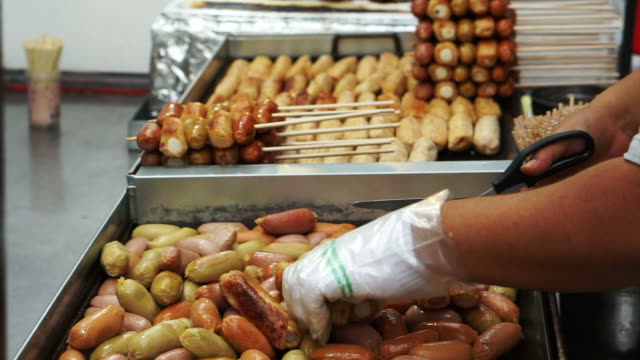Eomuk,-Korean-street-food.-Fried-fish-cake,-sausage-and-hot-dog-on-stick-with-red-sauce-in-Seoul,-Korea