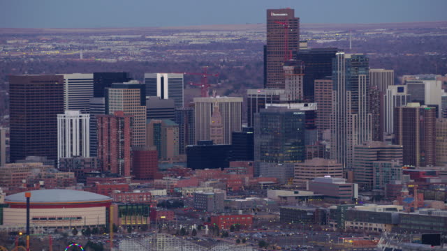 Zoom-out-from-downtown-Denver-buildings-at-dusk