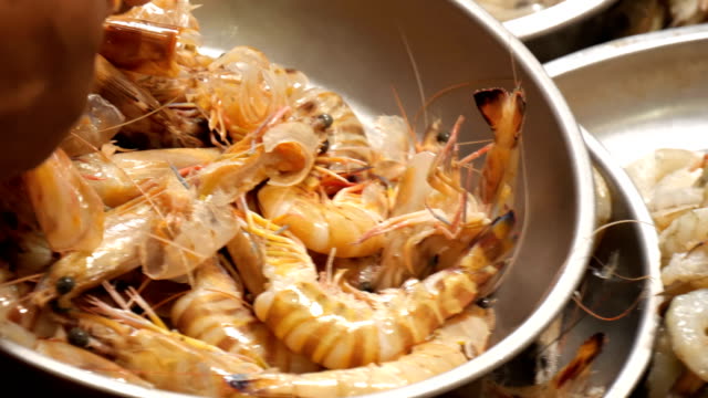 Hands-taking-off-shrimp-shells-before-cook.