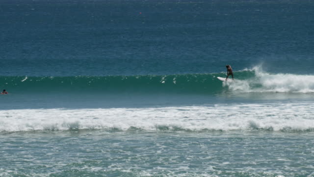 tracking-shot-of-a-young-man-surfing-the-famous-kirra