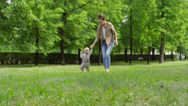 Mother-and-Crying-Baby-Walking-on-Grass