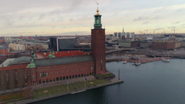 Stockholm-city-center-aerial-view.-Drone-shot-flying-by-Stockholm-City-Hall-and-up-over-cityscape-buildings-and-bridges.-Famous-landmark-in-The-Capital-city-of-Sweden