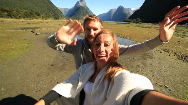 Young-couple-taking-selfie-portrait-at-Milford-Sound
