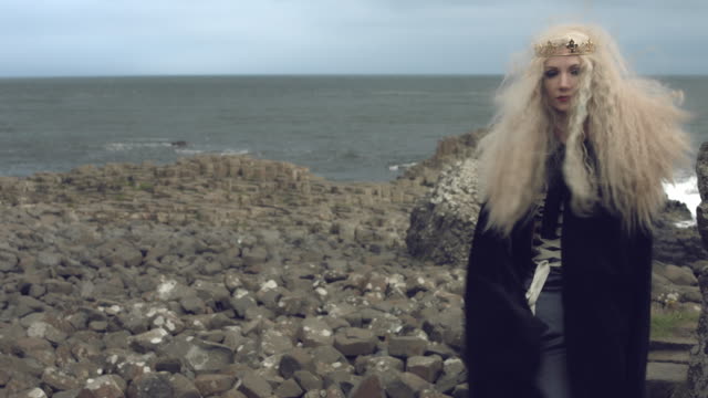4k-Fantasy-Shot-on-Giant's-Causeway-of-a-Queen-Looking-at-camera-(middle-shot)