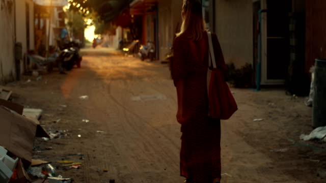 Following-Shot-of-a-Beautiful-Woman-in-a-Dress-Walking-Through-the-Streets-of-the-Authentic-Village.-Scenic-South-Asia-View.-Traveling-Alone.