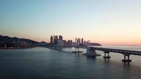 Gwangan-Bridge-and-Haeundae-aerial-view-at-Sunrise,-Busan,-South-Korea.