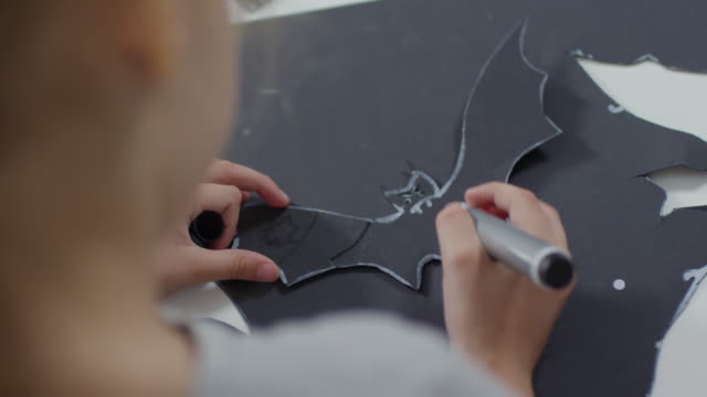 Little-Girl-Drawing-on-Halloween-Paper-Bat