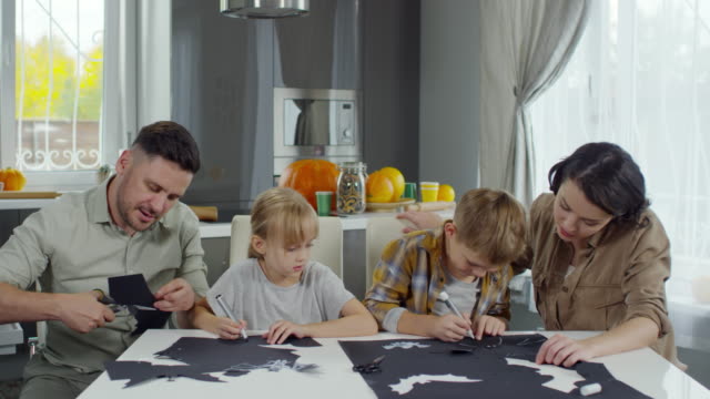 Parents-and-Kids-Making-Halloween-Decorations-Together