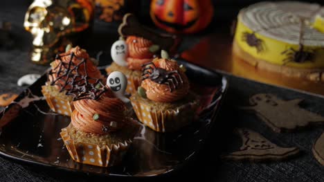 Fancy-Halloween-food-Party-Table-with-Pumpkin-Cupcake-Muffin-and-cookies.