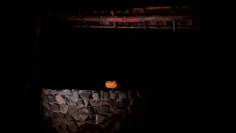 Abandoned-well-in-the-forest-with-Halloween-pumpkin-at-night.-Horror-concept