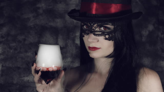 4k-Halloween-Shot-of-a-Witch-Holding-a-Glass-with-Smoke-and-Poison