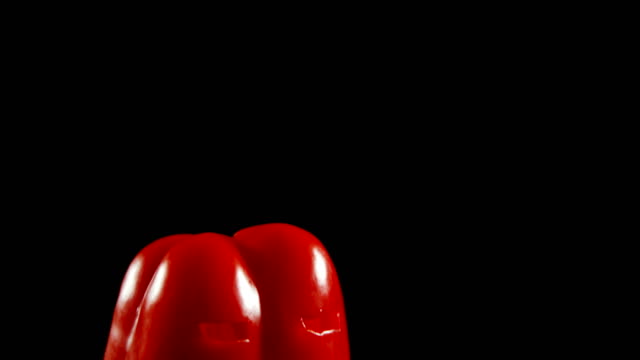Halloween-red-pepper-against-black-background-4k
