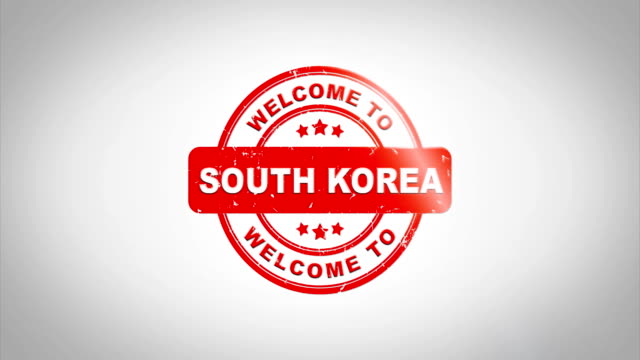 Bienvenido-a-Corea-del-sur-firmado-sellado-de-madera-sello-de-animación-de-texto.-Tinta-roja-en-el-fondo-de-superficie-de-papel-blanco-limpio-con-verde-mate-fondo-incluido.