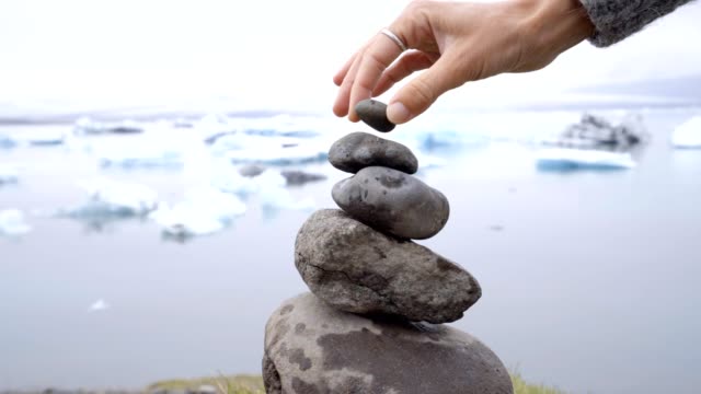 Detail-of-person-stacking-rocks-by-the-glacier-lagoon-in-Iceland