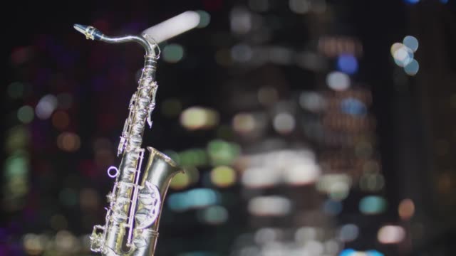 Saxophone-on-the-background-of-the-night-skyscraper