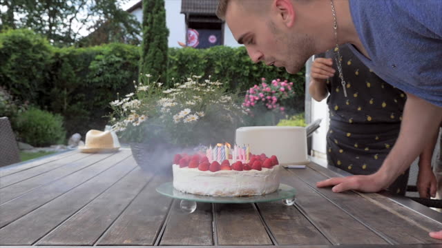 Young-Man-Blows-Out-Birthday-Candles