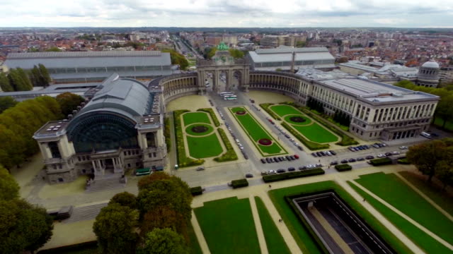 Large-green-park-in-Belgium,-car-tunnel-under,-aerial-city.-Beautiful-aerial-shot-above-Europe,-culture-and-landscapes,-camera-pan-dolly-in-the-air.-Drone-flying-above-European-land.-Traveling-sightseeing,-tourist-views-of-Belgium.