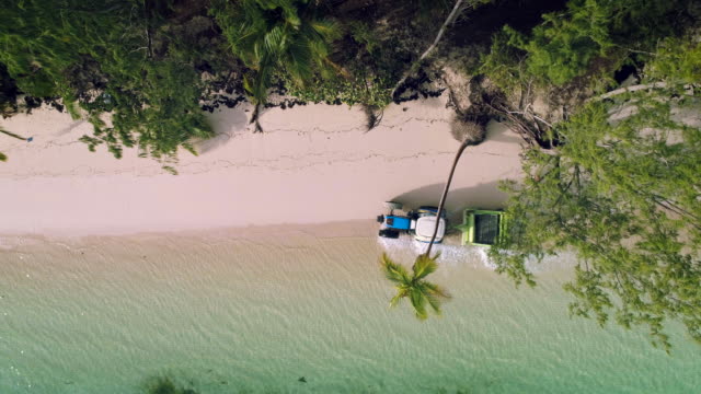 Tropical-island-beach-and-Beach-Sand-Cleaning-Truck,-aerial-view