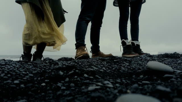 Nahaufnahme-der-Menschen-Fuß-steht-auf-der-schwarzen-Vulkanstrand-in-Island.-Touristen,-die-die-Insel-zu-erkunden