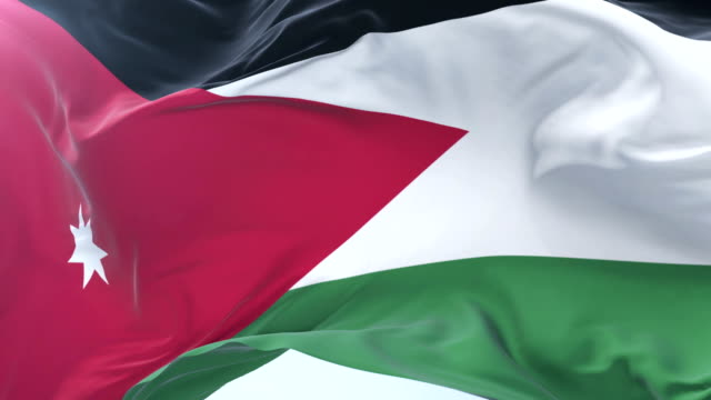 Flag-of-Jordan-waving-at-wind-with-blue-sky-in-slow,-loop