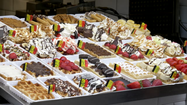 display-of-fresh-belgian-waffles-small-with-flags-in-brussels