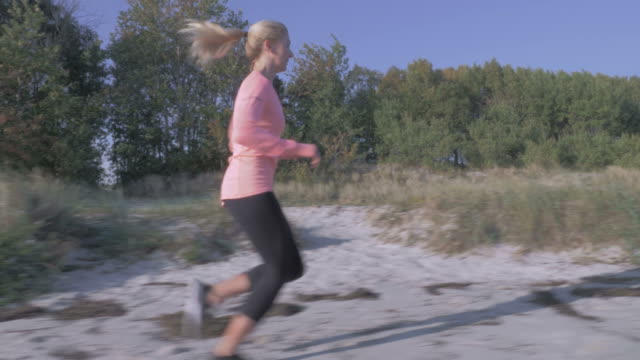 woman-jogging-along-the-sea-coast