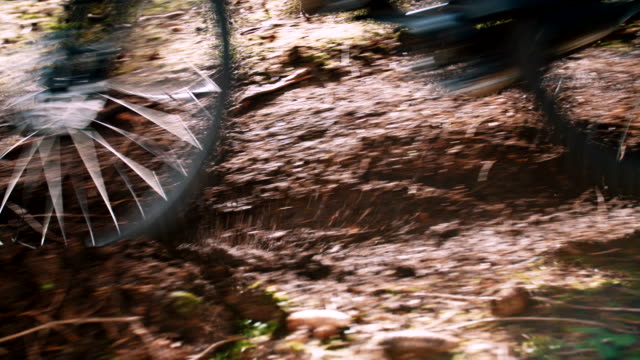 Close-up-of-mountain-bike-tyre-through-dirt-slow-motion