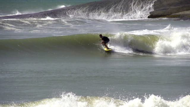 SLOW-MOTION:-Young-surfer-riding-big-wave