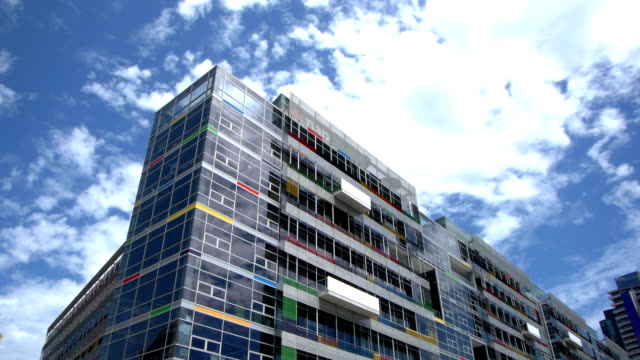 Sky-moving-on-coloured-building