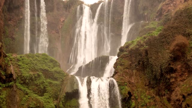 timelapse-pan-down-Ouzoud-Waterfalls-located-in-the-Grand-Atlas-village-of-Tanaghmeilt,-in-the-Azilal-province-in-Morocco,-Africa