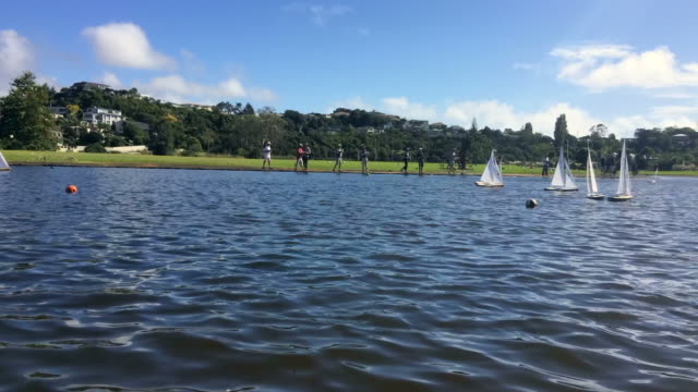 Time-lapse-of-remote-controlled-sailing-wooden-yachts-race-in-a-pond