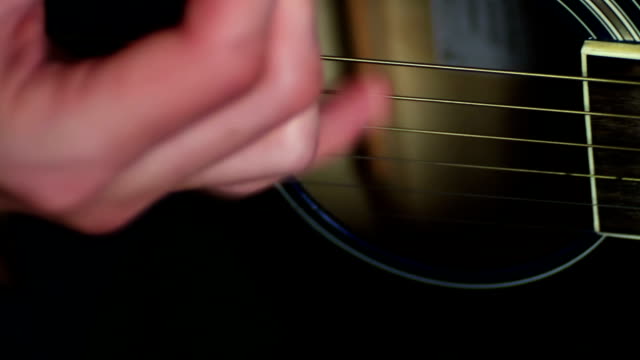 man-playing-Acoustic-guitar-close-up