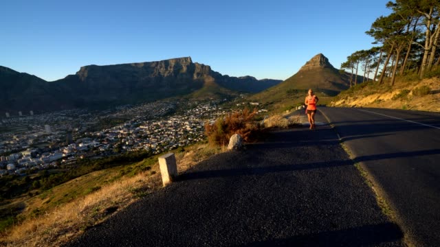 Young-woman-running-at-sunrise,-Cape-Town,-South-Africa