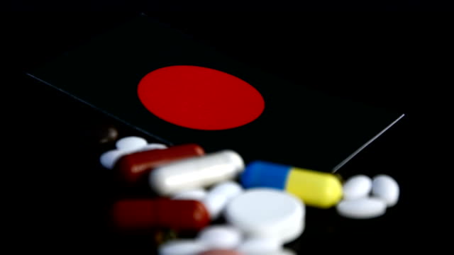 Bangladesh-flag-with-lot-of-medical-pills-isolated-on-black-background