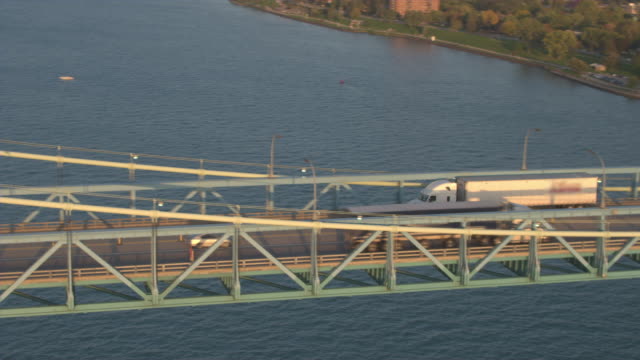 AERIAL:-Semi-trucks-driving-over-the-bridge-into-the-logistics-center-in-Detroit