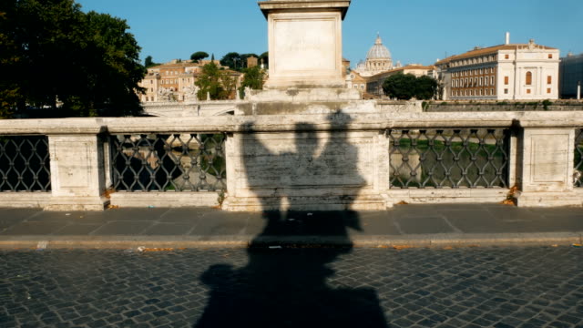 shadow-of-angel-on-the-bridge-of-castle-sant-angelo,-Rome