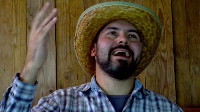 Laughter-of-an-unshaven-man-in-a-straw-hat