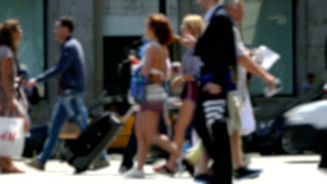 Side-view-blurry-pedestrians-walking.Time-Lapse.