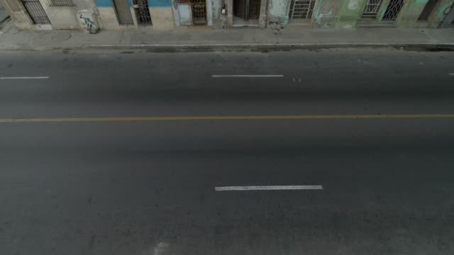 Vogelperspektive-Luftaufnahmen-zur-Gründung-Schuss-von-klassischen-amerikanischen-Autos-vorbei-an-der-Straße-von-Havanna,-Kuba