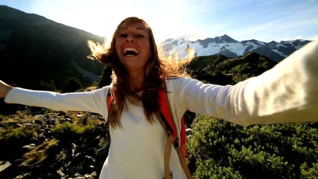 Junge-Frau-dauert-Selbstporträt-auf-Berge-im-Hintergrund