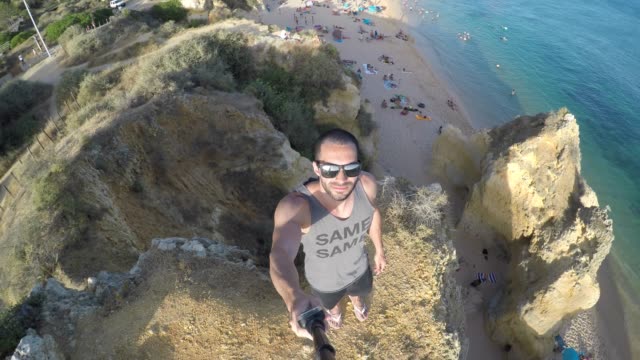 Guy-taking-a-selfie-in-a-beach-in-Algarve,-Portugal